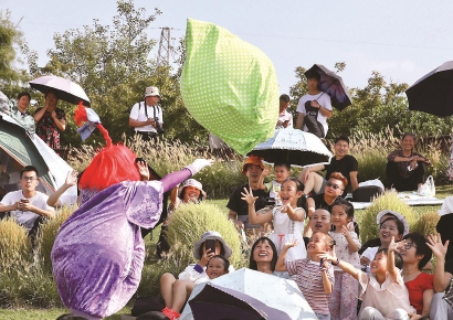 金山朱泾的花开海上生态园,来自俄罗斯的马戏团演员与游客互动交流.